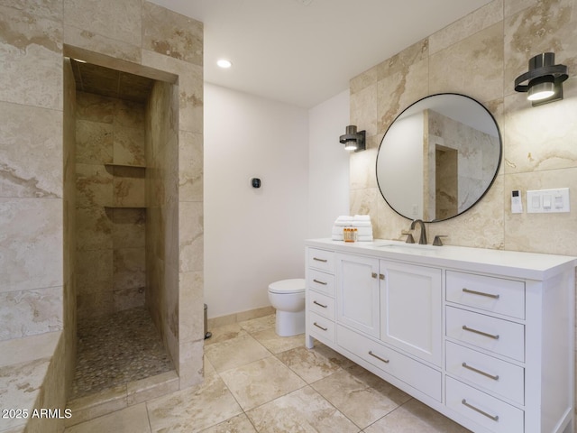 full bathroom with a walk in shower, toilet, vanity, and tile walls