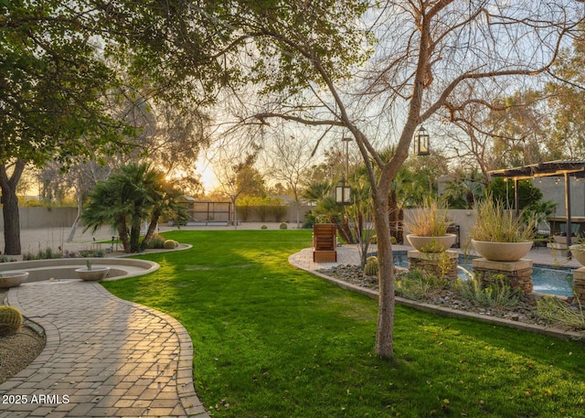 view of yard with a patio area, fence, and a pergola