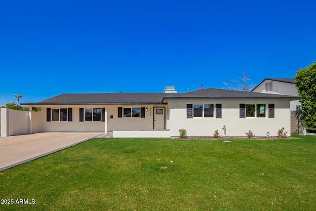 rear view of property with stucco siding, a patio, a lawn, and fence