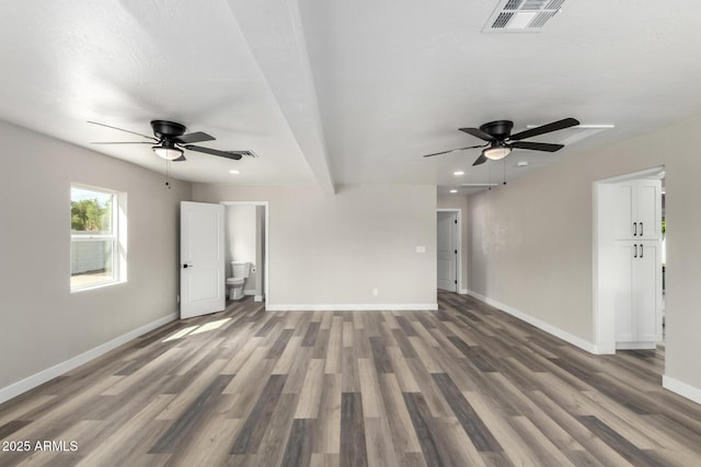 unfurnished living room with visible vents, baseboards, ceiling fan, and wood finished floors