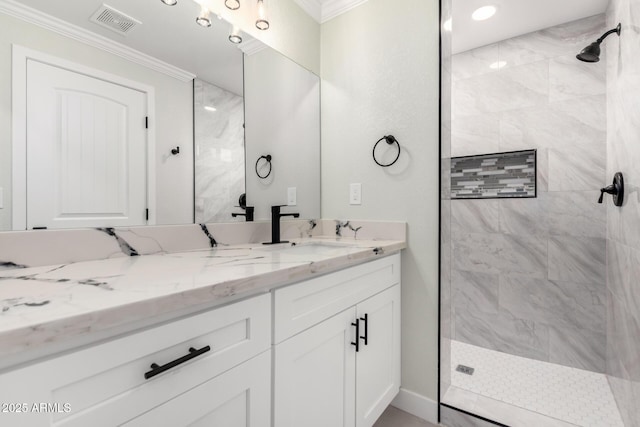 bathroom featuring vanity, visible vents, a tile shower, and ornamental molding