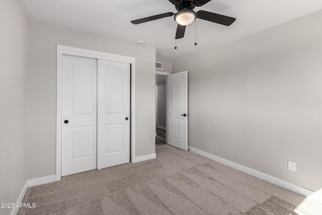 unfurnished bedroom with a closet, baseboards, carpet, and visible vents