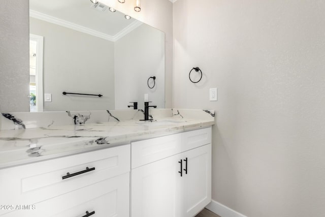 bathroom featuring vanity, baseboards, visible vents, and ornamental molding