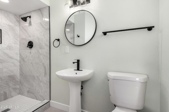 bathroom with toilet and tiled shower