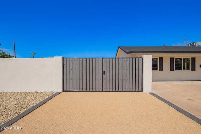 view of gate featuring fence