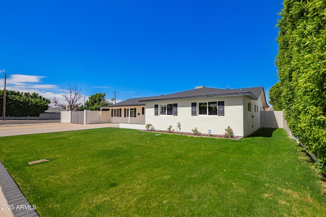 single story home with a fenced backyard, stucco siding, and a front lawn