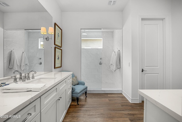 5542 E Alan Ln, Paradise Valley, AZ 85253 - bathroom with plenty of natural light, tiled shower, wood finished floors, and vanity