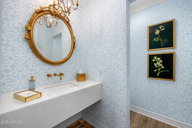 5542 E Alan Ln, Paradise Valley, AZ 85253 - bathroom with wallpapered walls, wood finished floors, a sink, a chandelier, and baseboards