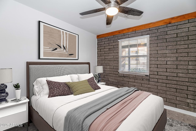 bedroom with ceiling fan and brick wall