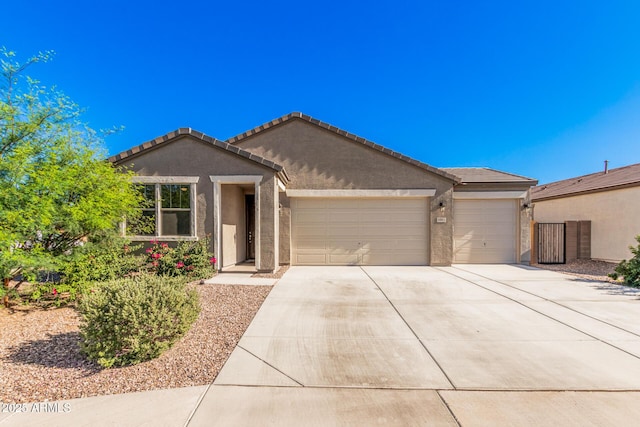 1005 W Lincoln Ave, Coolidge, AZ 85128 - single story home featuring a garage, driveway, stucco siding, and a tiled roof
