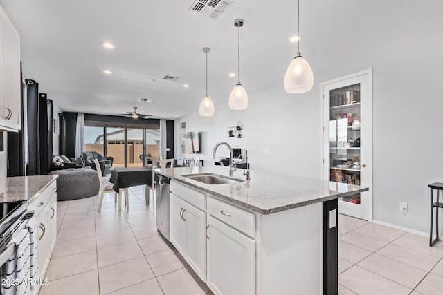 1005 W Lincoln Ave, Coolidge, AZ 85128 - kitchen with a sink, open floor plan, a ceiling fan, appliances with stainless steel finishes, and light stone counters