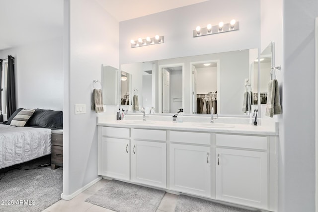 1005 W Lincoln Ave, Coolidge, AZ 85128 - full bath featuring double vanity, tile patterned floors, ensuite bathroom, and baseboards