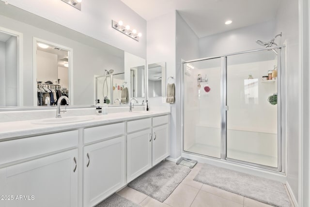 1005 W Lincoln Ave, Coolidge, AZ 85128 - bathroom featuring tile patterned flooring, a stall shower, double vanity, and a spacious closet