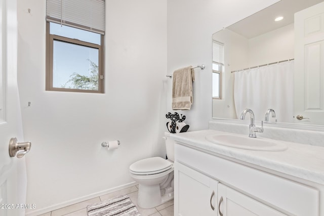 1005 W Lincoln Ave, Coolidge, AZ 85128 - bathroom with plenty of natural light, toilet, vanity, and tile patterned floors