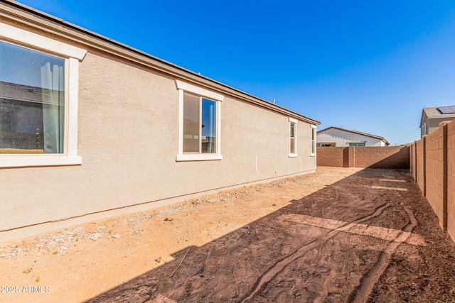 1005 W Lincoln Ave, Coolidge, AZ 85128 - view of side of home featuring a fenced backyard and stucco siding