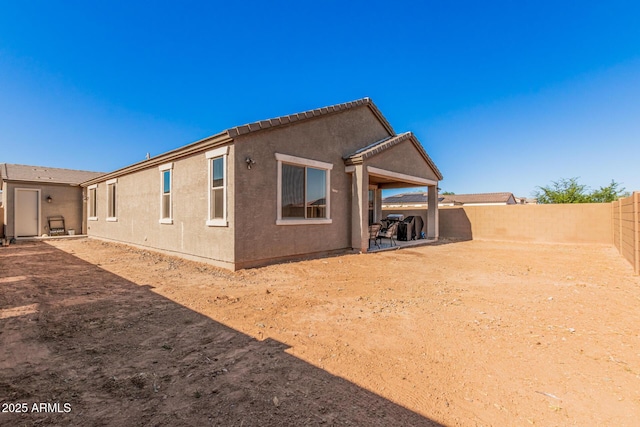 1005 W Lincoln Ave, Coolidge, AZ 85128 - rear view of house with a fenced backyard, stucco siding, and a tiled roof