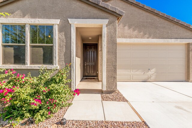 1005 W Lincoln Ave, Coolidge, AZ 85128 - doorway to property with concrete driveway, stucco siding, and a garage