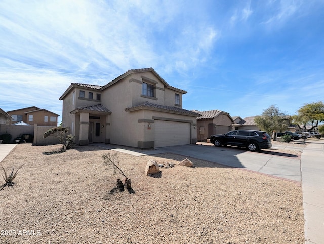 mediterranean / spanish house with a garage, concrete driveway, a tiled roof, a residential view, and stucco siding