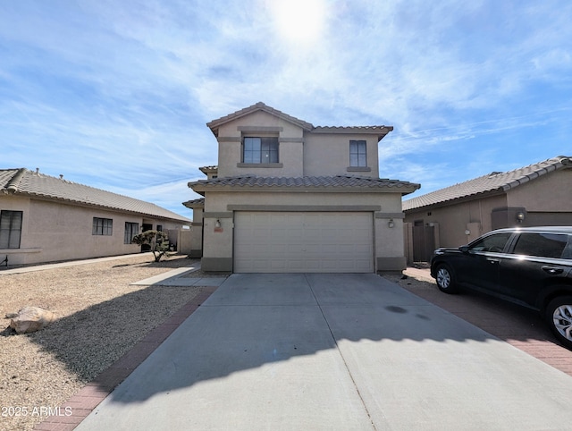 traditional home featuring a garage, stucco siding, concrete driveway, and a tiled roof