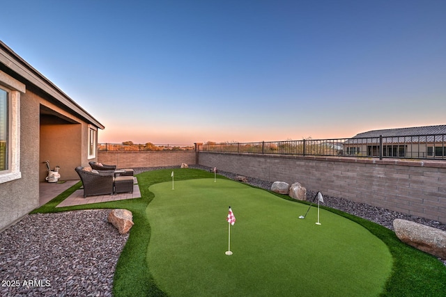 yard at dusk with a patio area