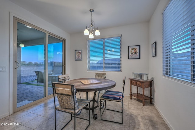 dining room featuring a chandelier and light tile patterned floors