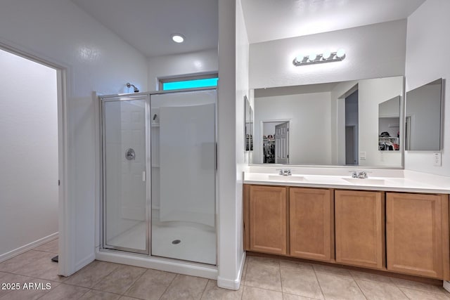 bathroom with vanity, an enclosed shower, and tile patterned floors