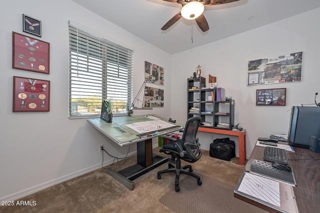 carpeted office space featuring ceiling fan