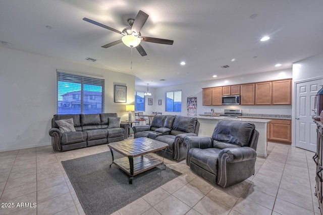 living room with light tile patterned floors and ceiling fan