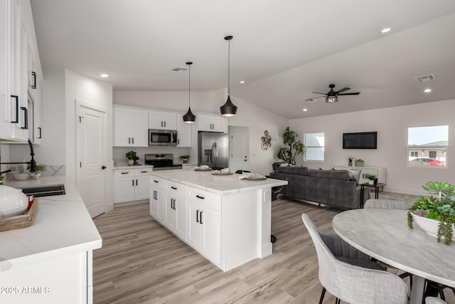 kitchen with white cabinetry, visible vents, appliances with stainless steel finishes, and open floor plan