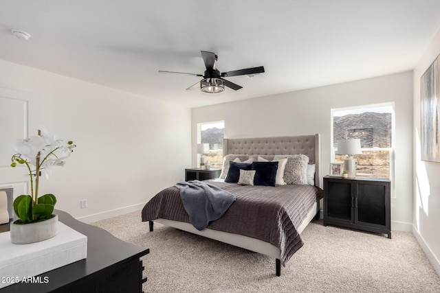 bedroom with baseboards, a ceiling fan, and light colored carpet