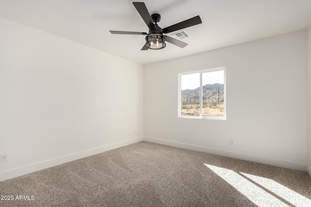 unfurnished room featuring a ceiling fan, carpet, visible vents, and baseboards