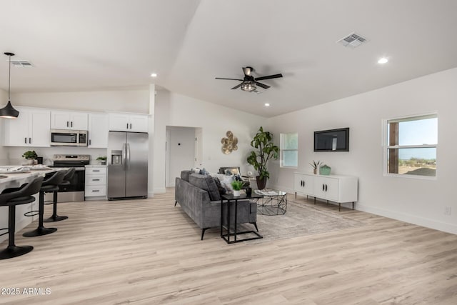 living area with lofted ceiling, recessed lighting, visible vents, a ceiling fan, and light wood-type flooring