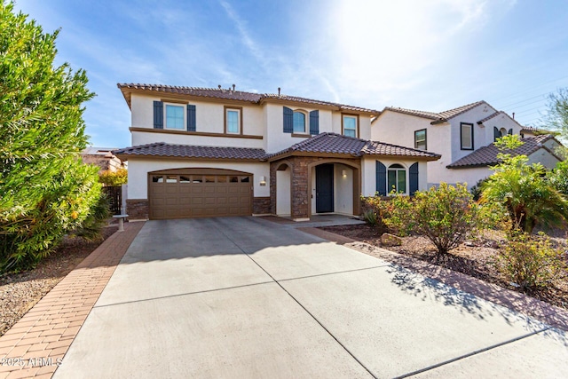 mediterranean / spanish-style home featuring a garage