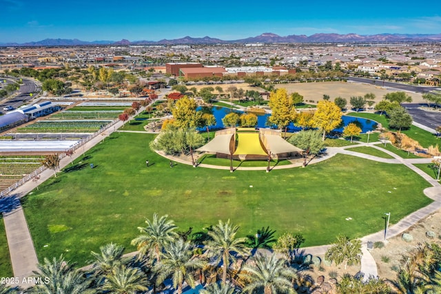 birds eye view of property with a water and mountain view