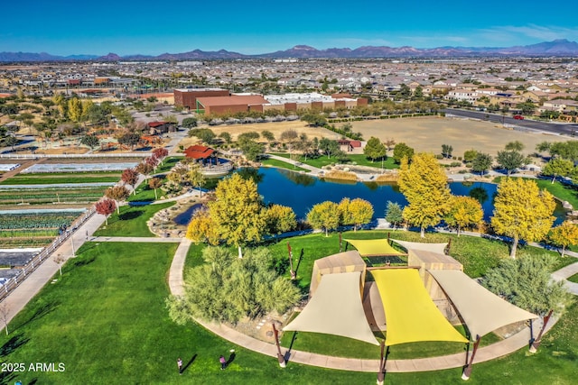 birds eye view of property with a water and mountain view