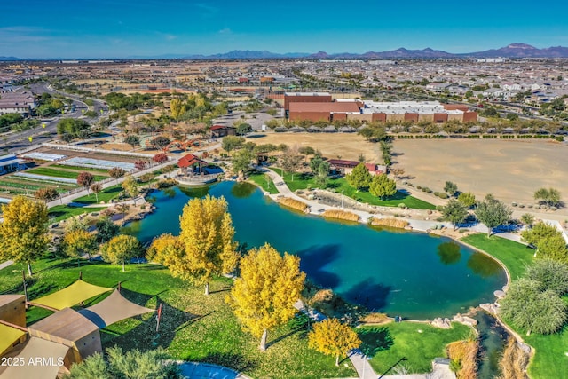 birds eye view of property with a water and mountain view