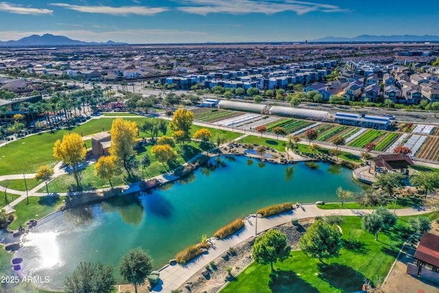 birds eye view of property with a water and mountain view