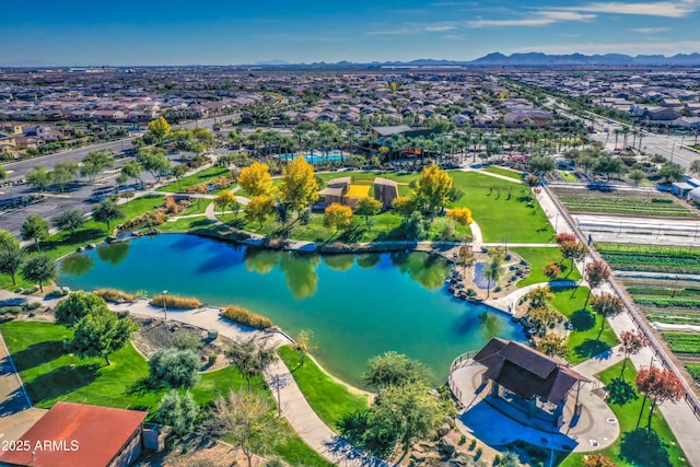 birds eye view of property with a water and mountain view