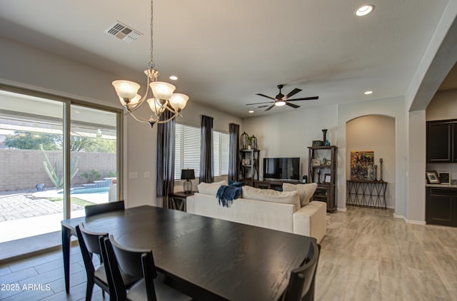 dining room featuring ceiling fan with notable chandelier and light wood-type flooring