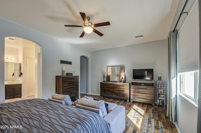 bedroom with ceiling fan, dark hardwood / wood-style flooring, sink, and connected bathroom