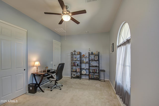 home office featuring ceiling fan and light carpet