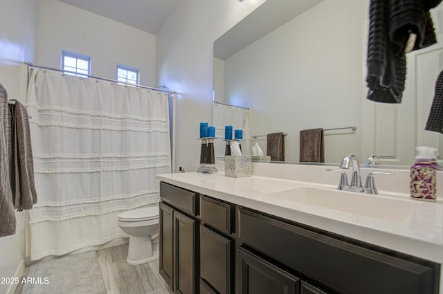 bathroom featuring toilet and vanity