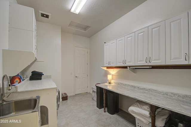 washroom featuring sink and cabinets