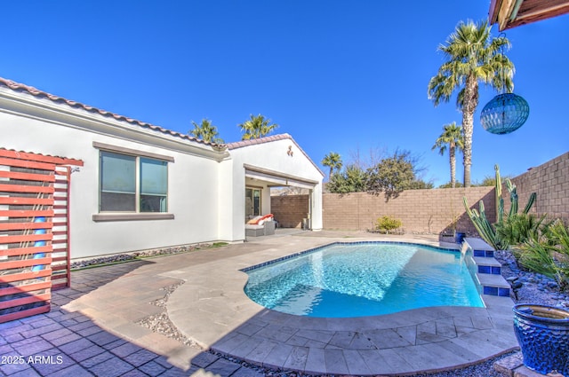 view of swimming pool featuring pool water feature and a patio