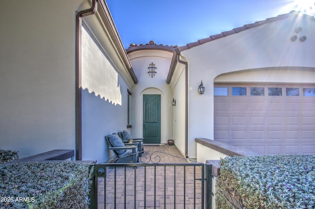 view of exterior entry featuring a garage