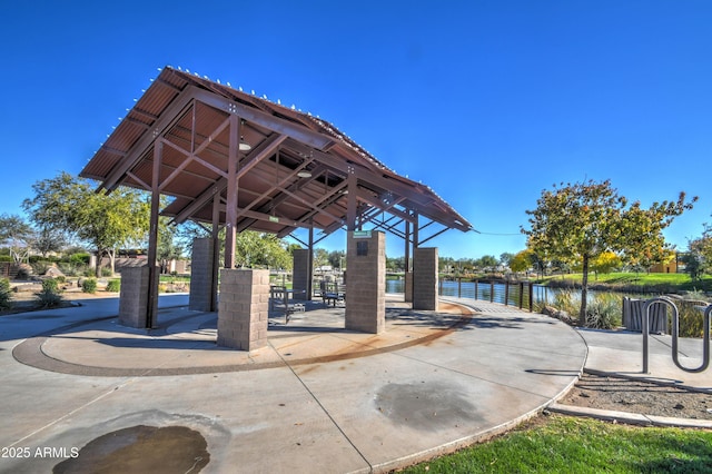 view of home's community with a gazebo and a water view