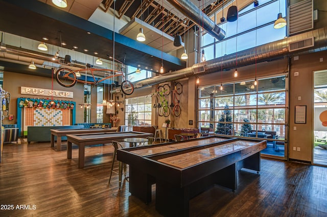 rec room featuring hardwood / wood-style floors, billiards, and a towering ceiling