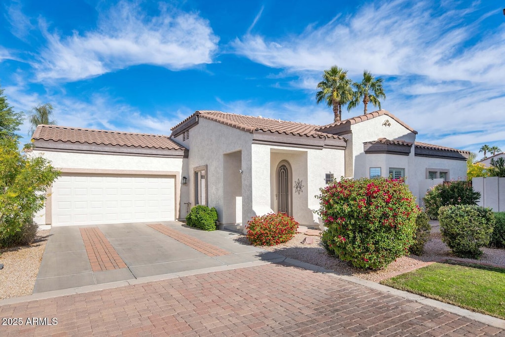 mediterranean / spanish home with a garage