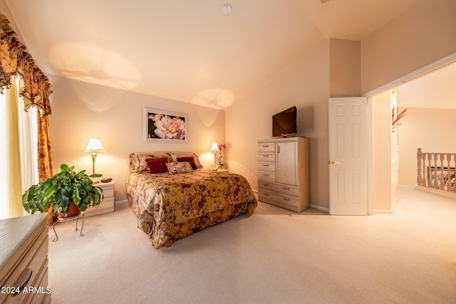 bedroom featuring light colored carpet and vaulted ceiling