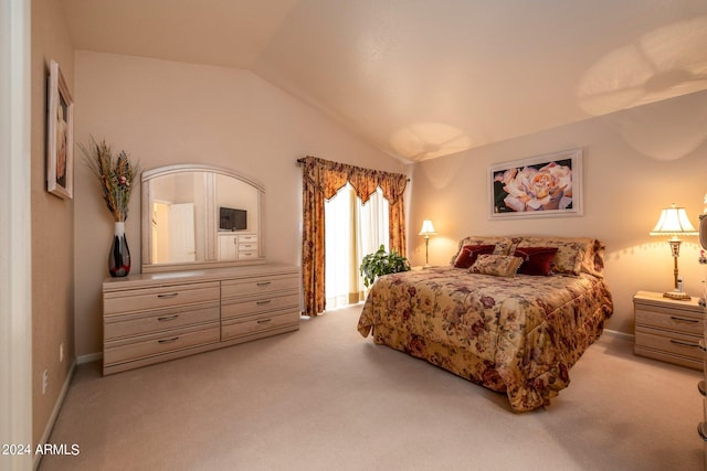 bedroom with light colored carpet and lofted ceiling